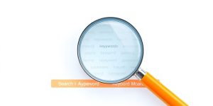 Magnifying glass over a search bar with keywords.
