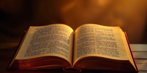 Ancient book with glowing pages and warm light.