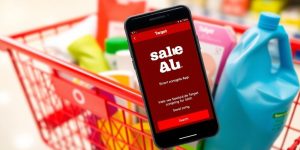Shopping cart with colorful items and Target Sale App.