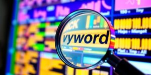 Magnifying glass over vibrant digital interface for keyword analysis.