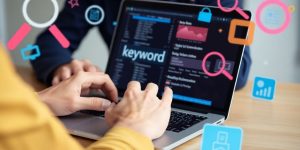 Person analyzing keyword searches on a laptop.
