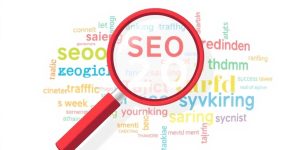 Magnifying glass with colorful keywords related to SEO.