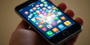 Colorful app icons radiating from a smartphone.