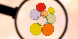 Magnifying glass over diverse colored keyword bubbles